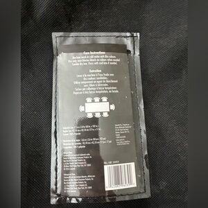 Cuisinart tablecloth and cloth napkins. Black with rectangular pattern.